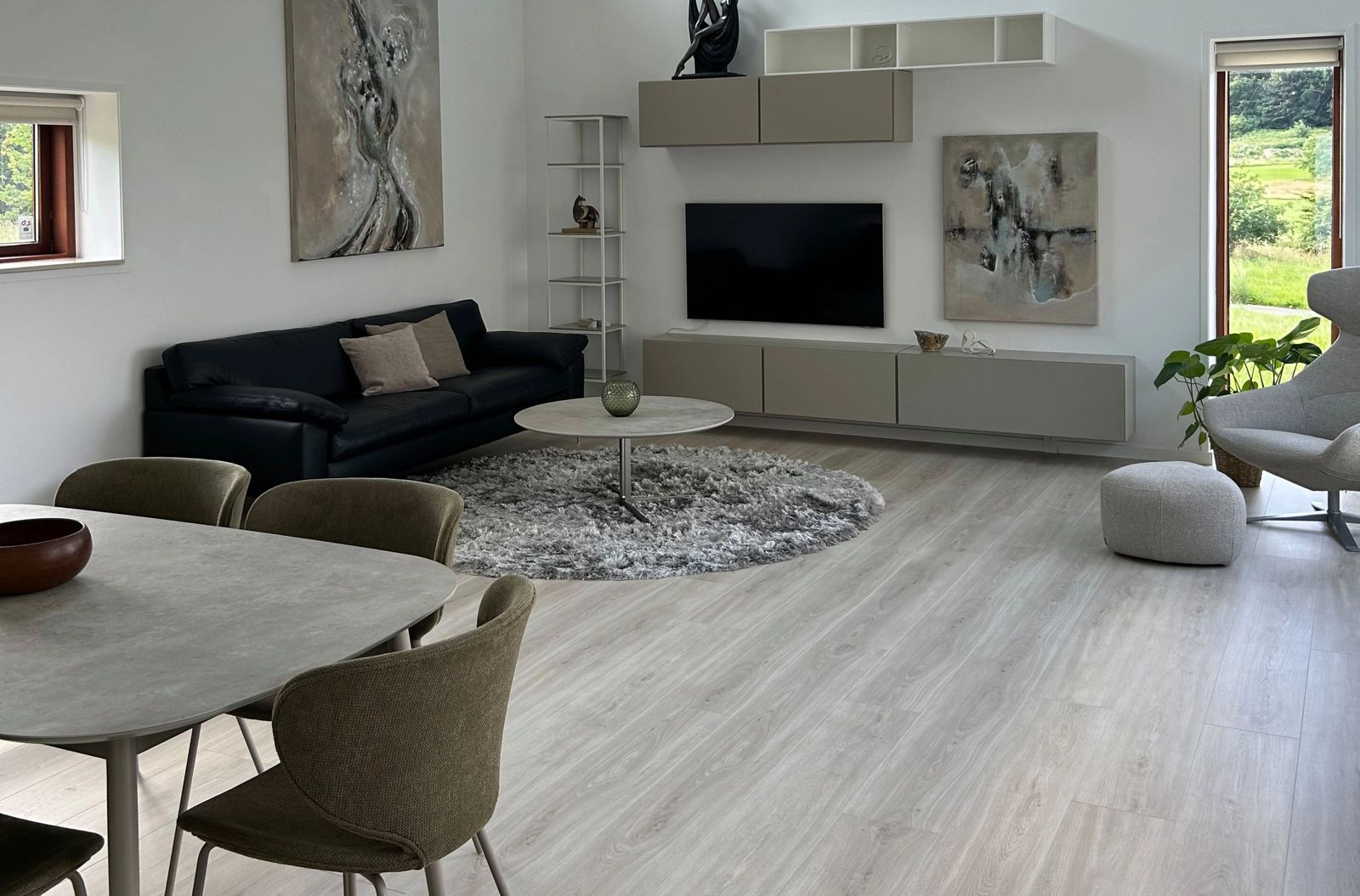 Living room with custom sofa, entertainment wall, dining area and lounge chair